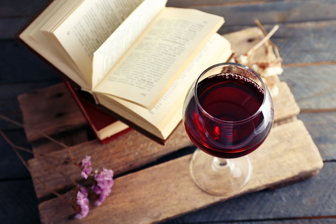 Glass of Wine and Books on a Table